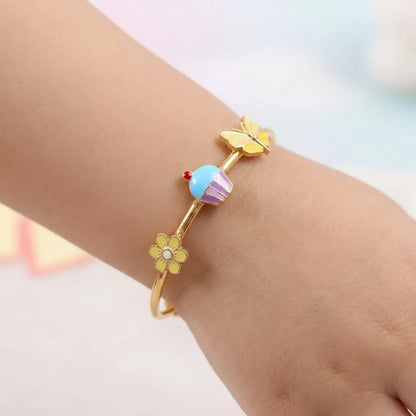 Silver Sweet Bloom Silver Kada – Flower, Cupcake & Butterfly – Product shown on a child’s wrist