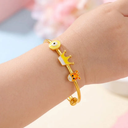 Silver Lucky Charm Kada Kada – Evil Eye, Crown & Giraffe – Product shown on a child’s wrist