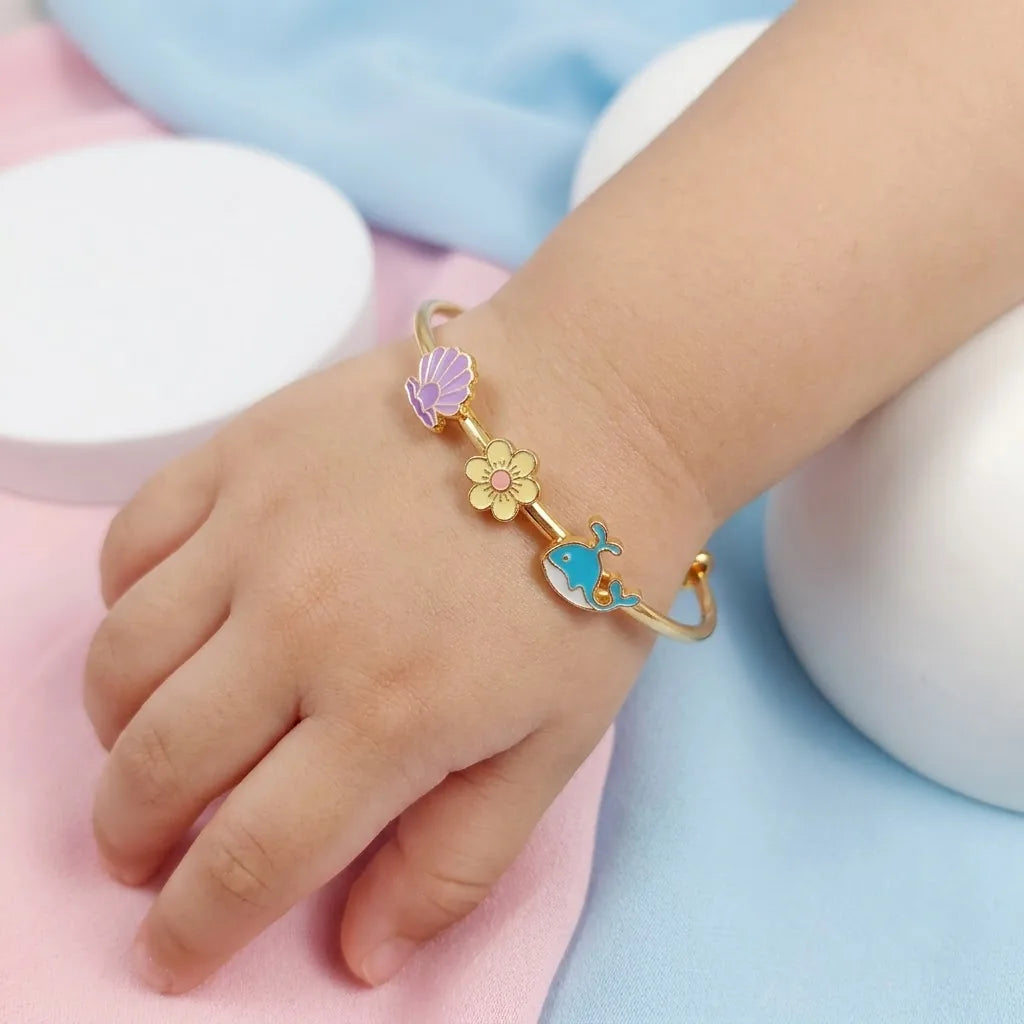 Silver Ocean Dreams Kada Kada – Seashell, Flower & Dolphin – Product shown on a child’s wrist