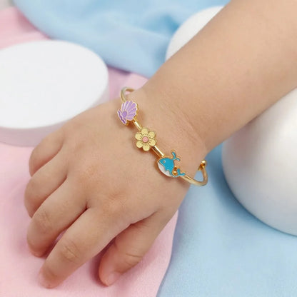 Silver Ocean Dreams Kada Kada – Seashell, Flower & Dolphin – Product shown on a child’s wrist