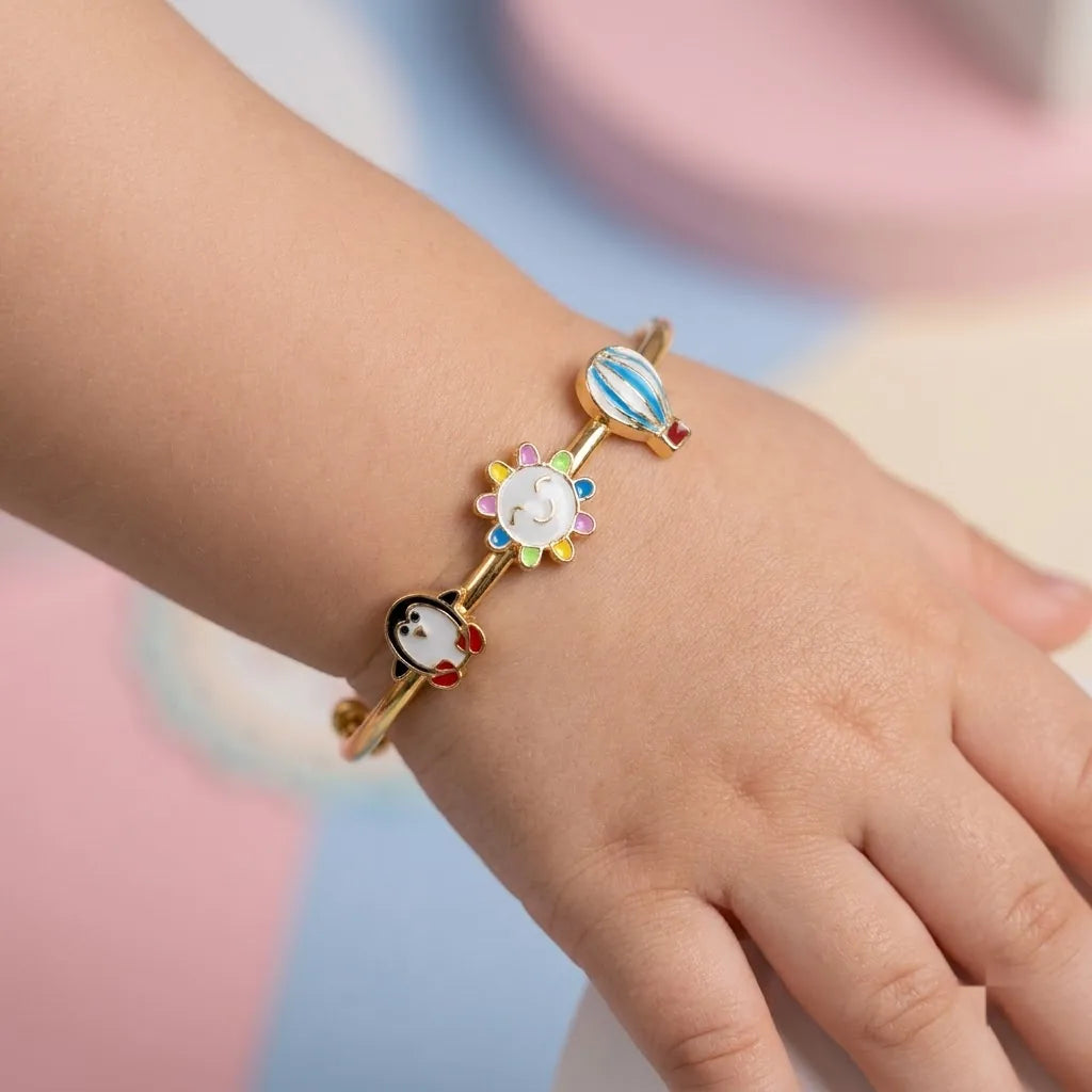 Silver Sunshine Adventure Silver Kada – Penguin, Smiling Sun & Hot Air Balloon – Product shown on a child’s wrist