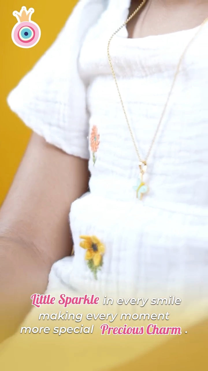 A child wearing an Arista pendant to show where a chain can sit