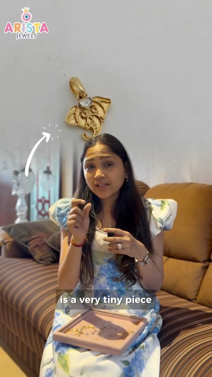 An Arista team member showing and explaining a jewellery piece